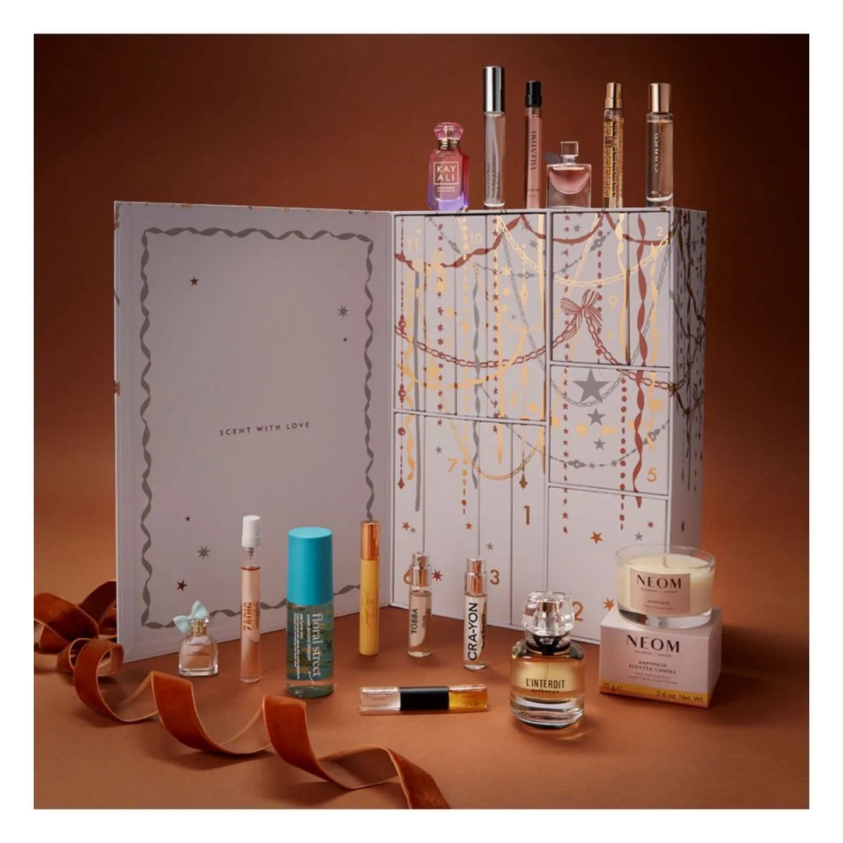 The Boots 12 Days of Scent advent calendar open, showing twelve numbered drawers and the fragrances inside, including Givenchy L'Interdit, Kayali, Versace, Prada, Floral Street, Ghost and a NEOM candle