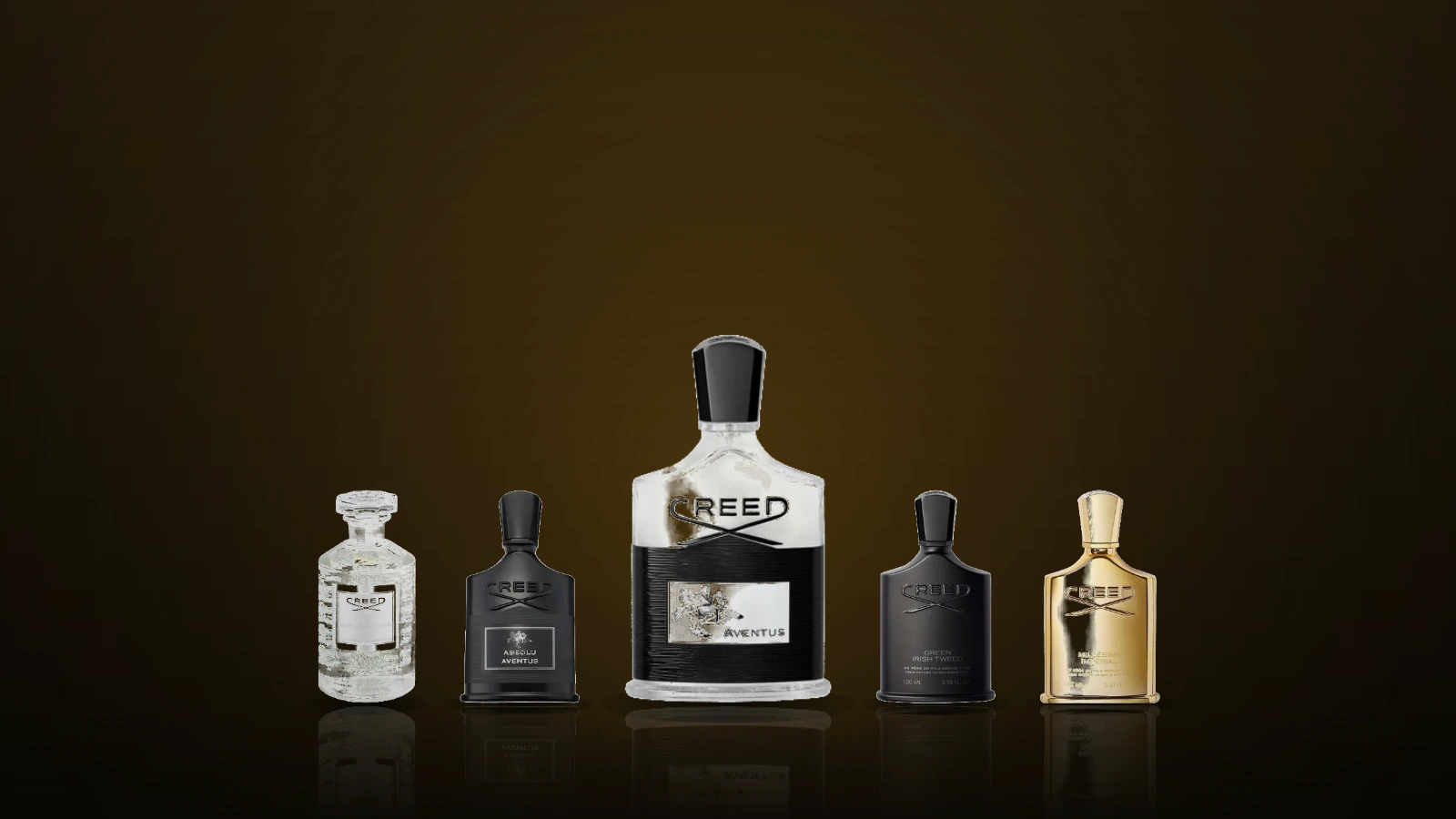 Plain glass fragrance bottles on a dark marble shelf beside a folded linen jacket