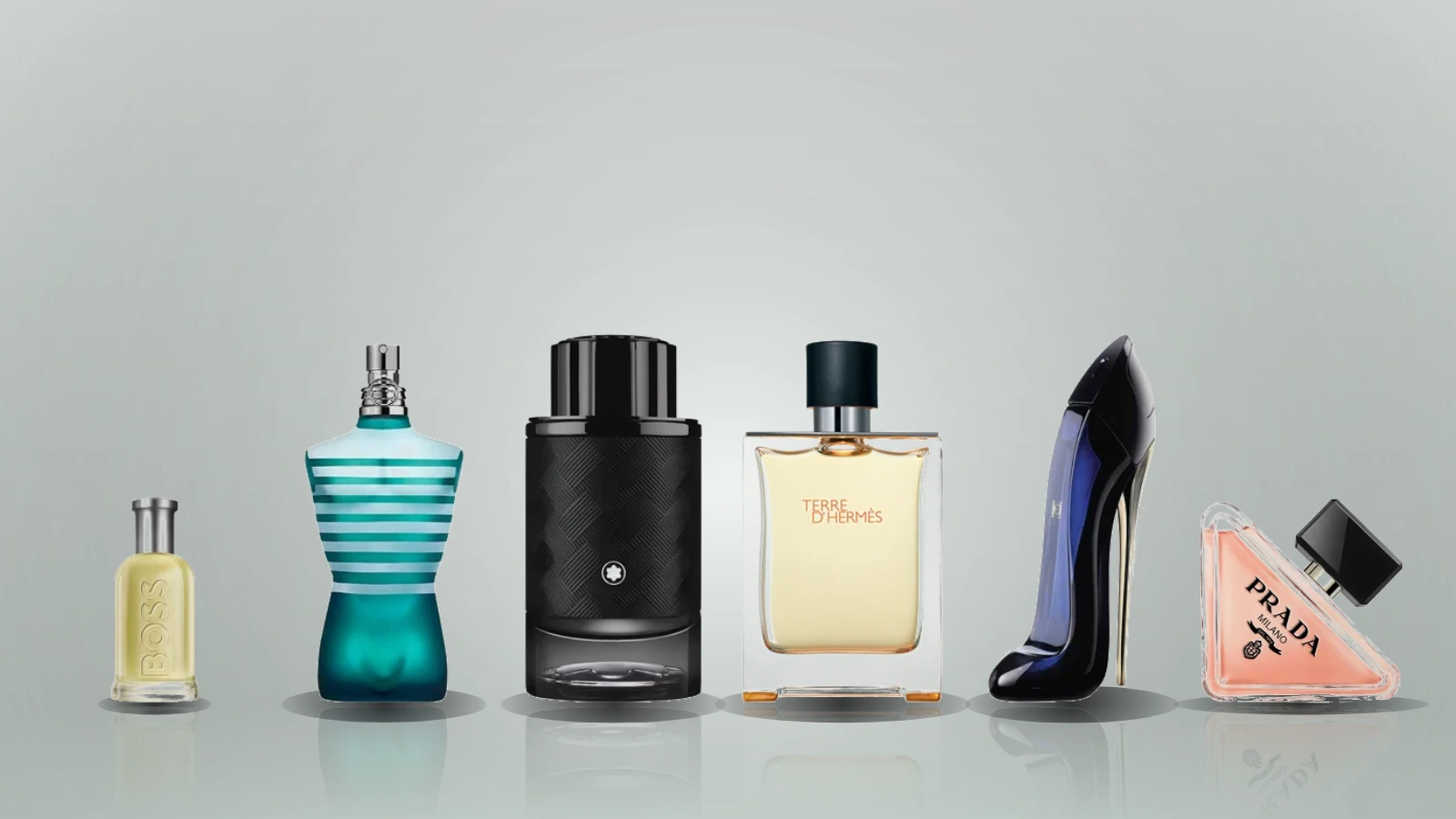 A stack of boxed fragrance gift sets including Boss Bottled, Le Male, Prada Paradoxe, La Vie Est Belle, YSL Libre and CK One, each pairing a bottle with a matching toiletry