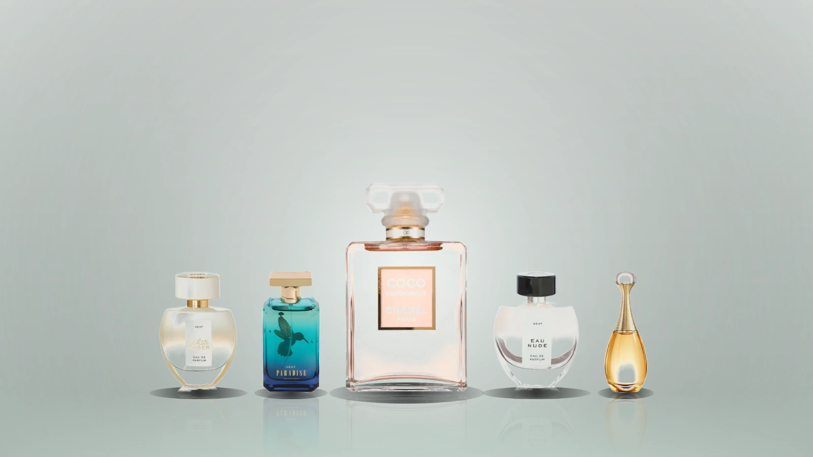 A collection of various perfume bottles arranged on a dark marble surface, featuring distinct shapes and colors, with soft lighting highlighting their details
