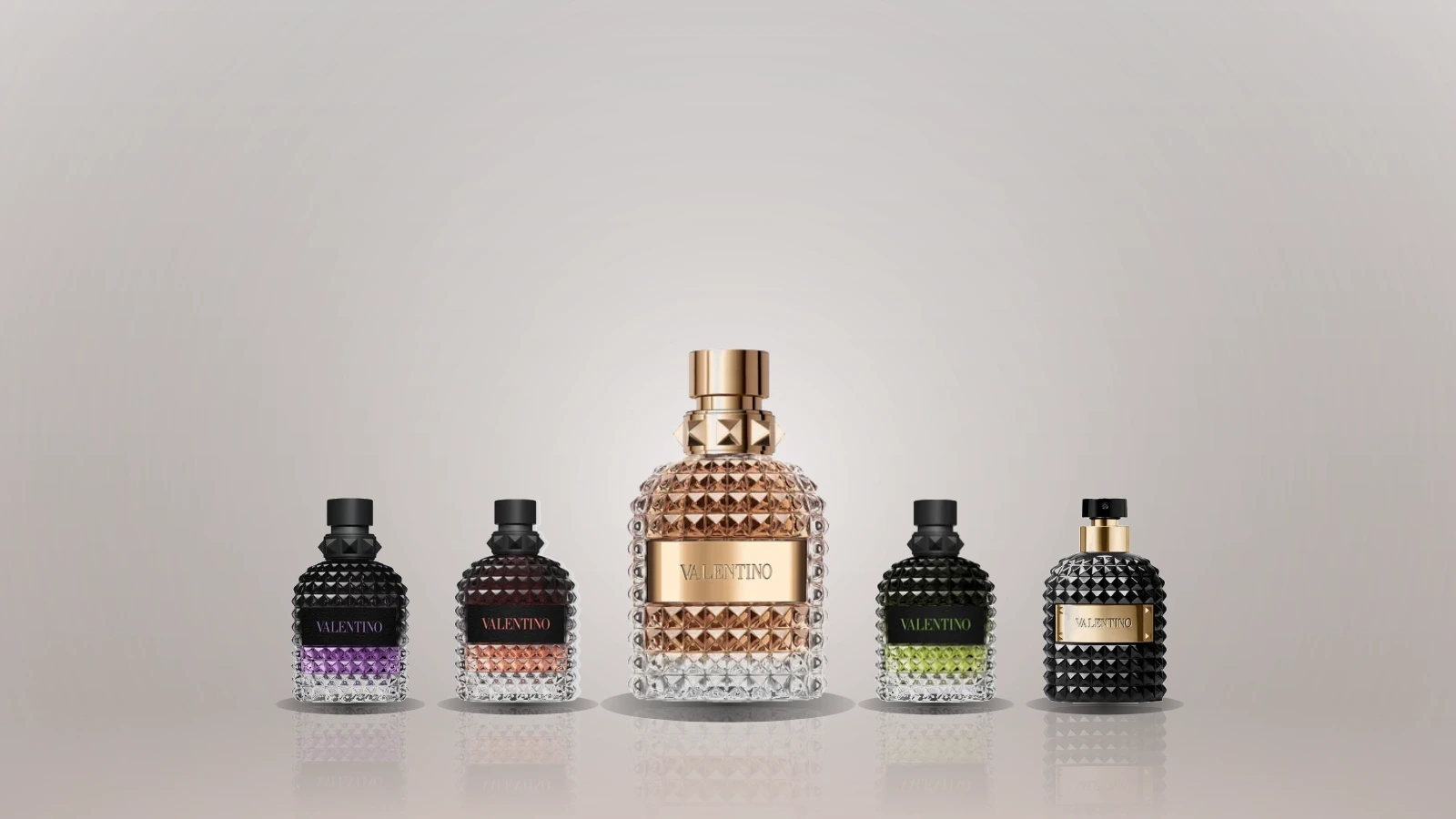 Plain glass fragrance bottles on a marble ledge in warm evening light, with a Roman terrace behind