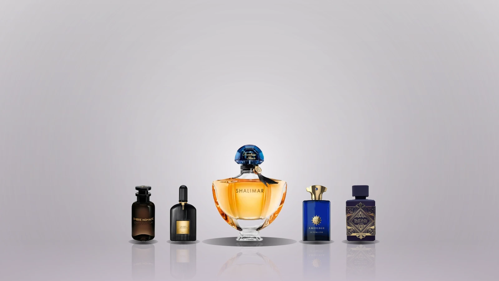 A collection of various perfume bottles arranged on a wooden surface, surrounded by spices and decorative elements, with a blurred background of a dimly lit room