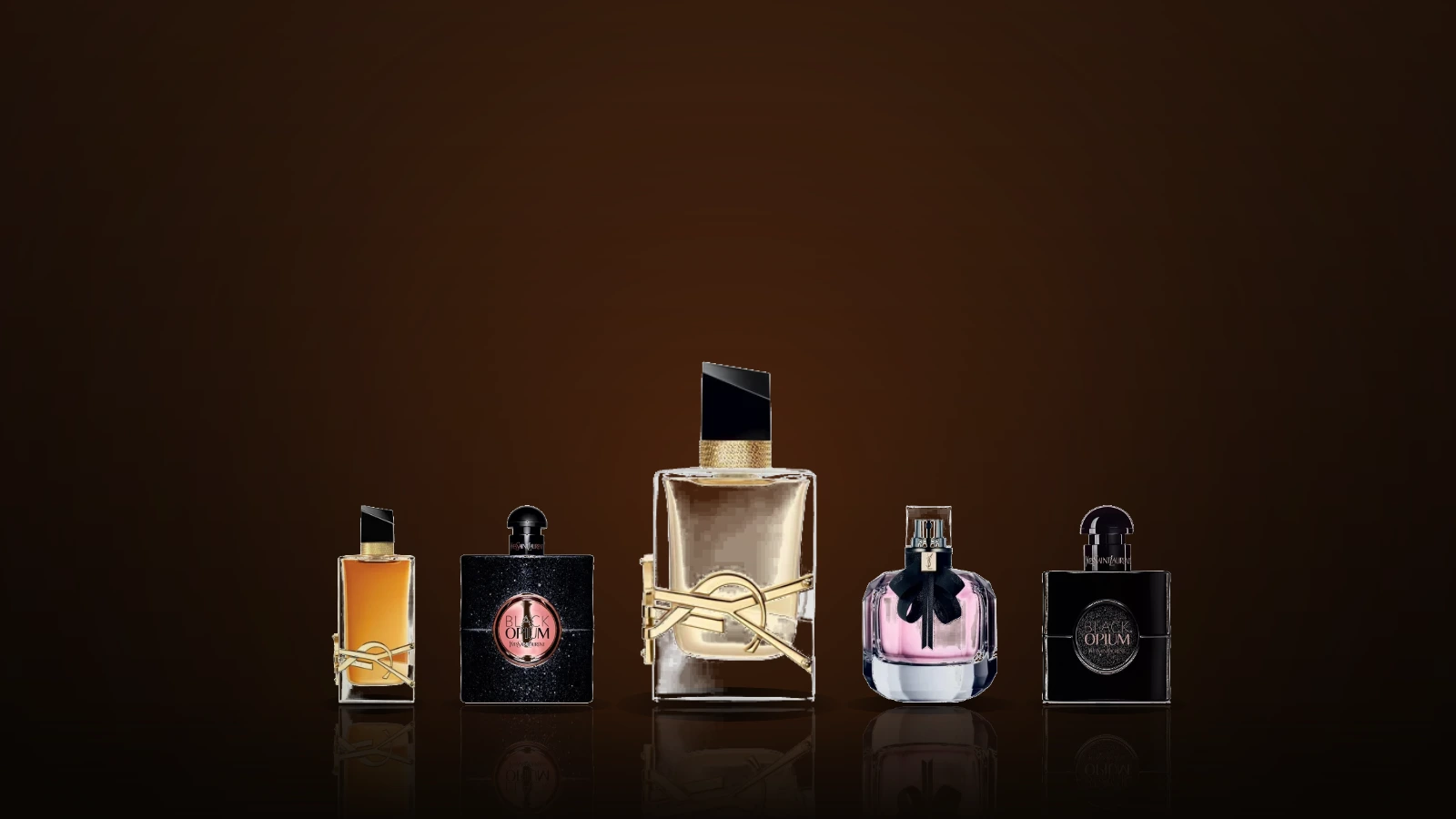 A row of plain glass perfume bottles on a dark marble ledge with warm evening light and a Paris rooftop skyline behind