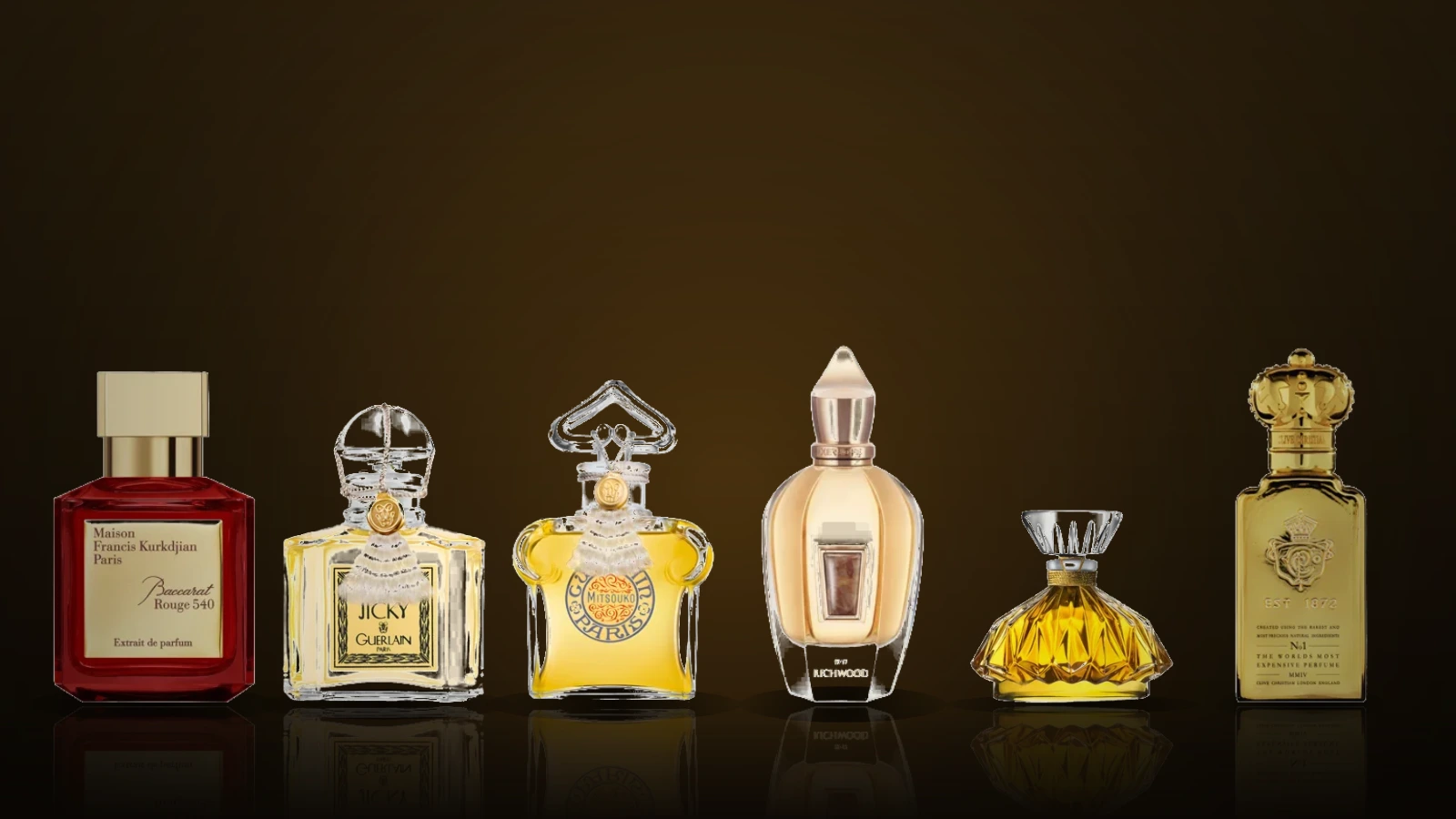 A small group of luxury perfume bottles including Maison Francis Kurkdjian Baccarat Rouge 540, Guerlain Mitsouko Extrait and a Clive Christian bottle, arranged on a dark surface